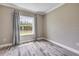 Bedroom with luxury vinyl plank flooring and a window that lets in natural light to brighten up the space at 1012 Bradford Ridge Dr, Leesburg, FL 34748