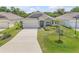 Inviting exterior view of a single-story home featuring well-manicured lawn and complemented by mature trees at 1012 Bradford Ridge Dr, Leesburg, FL 34748