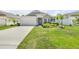 Charming single-story home with a lush front yard and a long driveway at 1012 Bradford Ridge Dr, Leesburg, FL 34748