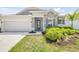 Attractive single-Gathering home featuring stone detailing, two-car garage and beautifully landscaped front yard at 1012 Bradford Ridge Dr, Leesburg, FL 34748