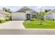 Charming single-story home featuring stone accents, well-maintained landscaping, and a spacious two-car garage at 1012 Bradford Ridge Dr, Leesburg, FL 34748