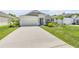 Charming one-story home featuring a two-car garage, attractive landscaping, and a well-manicured lawn at 1012 Bradford Ridge Dr, Leesburg, FL 34748