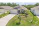 Charming one-story home featuring a two-car garage, attractive landscaping, and a well-manicured lawn at 1012 Bradford Ridge Dr, Leesburg, FL 34748