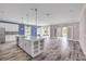 Modern kitchen with center island, stainless steel appliances, and open access to the living area at 1012 Bradford Ridge Dr, Leesburg, FL 34748