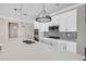 Modern kitchen featuring stainless steel appliances, white cabinets, and mosaic backsplash on the countertops at 1012 Bradford Ridge Dr, Leesburg, FL 34748