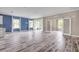 Open-concept living area with blue accent wall, ample natural light, and sliding door access to the outdoors at 1012 Bradford Ridge Dr, Leesburg, FL 34748