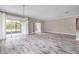 Bright and airy living space with sliding doors, modern lighting, and wood-look flooring at 1012 Bradford Ridge Dr, Leesburg, FL 34748