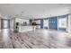 Open-concept living space featuring modern kitchen, wood-look tile flooring, and recessed lighting at 1012 Bradford Ridge Dr, Leesburg, FL 34748