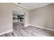 Open living room area featuring luxury vinyl plank flooring and neutral paint overlooking the kitchen at 1012 Bradford Ridge Dr, Leesburg, FL 34748