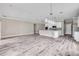 Spacious open-concept layout featuring a kitchen and living area with wood-look flooring and recessed lights at 1012 Bradford Ridge Dr, Leesburg, FL 34748