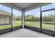 Enclosed patio with views of the lush backyard at 1012 Bradford Ridge Dr, Leesburg, FL 34748