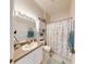 Well-lit bathroom featuring a vanity, toilet, shower with curtain, and decorative ocean themed elements at 106 Tuscany Villas Dr # 0160, Edgewater, FL 32141