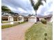 Attractive front exterior with brick driveway and well-manicured lawn at 106 Tuscany Villas Dr # 0160, Edgewater, FL 32141