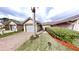 Charming one-story home with a well-manicured lawn, brick driveway, and a one-car garage at 106 Tuscany Villas Dr # 0160, Edgewater, FL 32141