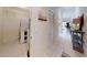 Bright hallway featuring tile floors, leading to a utility closet with washer and dryer units at 106 Tuscany Villas Dr # 0160, Edgewater, FL 32141