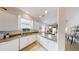 Well-lit kitchen with white cabinetry, contrasting countertops, and a view into the dining area at 106 Tuscany Villas Dr # 0160, Edgewater, FL 32141