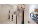 Functional laundry room with stacked washer/dryer, water heater, and storage cabinets at 106 Tuscany Villas Dr # 0160, Edgewater, FL 32141