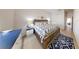 Cozy bedroom with nautical themed rug, wooden bed frame, and access to an adjacent hall at 106 Tuscany Villas Dr # 0160, Edgewater, FL 32141