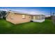 Spacious backyard with lush green grass and a screened in patio area, perfect for outdoor entertaining at 121 Ellicott Dr, Ormond Beach, FL 32176