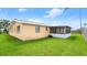 Spacious backyard with green grass and screened in patio at 121 Ellicott Dr, Ormond Beach, FL 32176