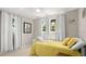 Bright bedroom featuring two windows, light walls, and a bed with decorative pillows at 121 Ellicott Dr, Ormond Beach, FL 32176