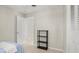 A clean and simple bedroom features a closet, an open doorway, and a small display shelf at 121 Ellicott Dr, Ormond Beach, FL 32176