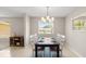 Bright dining room area with window views, neutral walls, and an elegant chandelier above the table at 121 Ellicott Dr, Ormond Beach, FL 32176