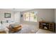 Bright living room with natural light, showcasing a soft sofa, unique area rug and built-in shelving at 121 Ellicott Dr, Ormond Beach, FL 32176