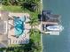 Stunning aerial view of waterfront home with a pool, hot tub, boat dock, and well-manicured landscaping at 1212 Commodore Dr, New Smyrna Beach, FL 32168