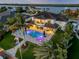Aerial view of waterfront home with pool, patio, and lush landscaping, offering stunning views at 1212 Commodore Dr, New Smyrna Beach, FL 32168