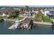 Aerial view of waterfront home with boat dock, lush landscaping, pool, and ample space for entertaining at 1212 Commodore Dr, New Smyrna Beach, FL 32168