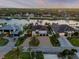 Aerial view of waterfront homes on a river with docks and boats, surrounded by palm trees at 1212 Commodore Dr, New Smyrna Beach, FL 32168