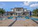 Expansive backyard with pool, outdoor kitchen, and lounge areas, perfect for entertaining guests at 1212 Commodore Dr, New Smyrna Beach, FL 32168