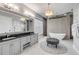 Bathroom with marble floors, a large vanity, a chandelier, and a soaking tub at 1212 Commodore Dr, New Smyrna Beach, FL 32168