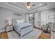 Stylish bedroom featuring a queen bed, a patterned armchair, and wood flooring at 1212 Commodore Dr, New Smyrna Beach, FL 32168