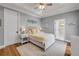 Cozy bedroom featuring a queen bed with a white frame and yellow accents, complemented by wood floors and natural light at 1212 Commodore Dr, New Smyrna Beach, FL 32168