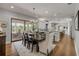 Dining room leading to kitchen and outdoor area, offering a seamless transition for entertaining and everyday living at 1212 Commodore Dr, New Smyrna Beach, FL 32168
