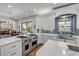 Charming kitchen with stainless appliances, white cabinetry, blue backsplash and breakfast nook at 1212 Commodore Dr, New Smyrna Beach, FL 32168