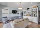Cozy living room with built in wine storage and display, comfortable seating, and natural light at 1212 Commodore Dr, New Smyrna Beach, FL 32168