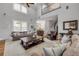 Open-concept living room with hardwood floors and staircase, showcasing a seamless flow throughout the home at 1212 Commodore Dr, New Smyrna Beach, FL 32168