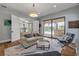 Comfortable living room offering seamless indoor/outdoor living through sliding glass doors to backyard pool at 1212 Commodore Dr, New Smyrna Beach, FL 32168
