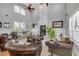Bright living room with a modern fireplace, high ceilings, and comfortable seating, designed for relaxation and entertainment at 1212 Commodore Dr, New Smyrna Beach, FL 32168