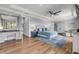 Spacious main bedroom with a king bed, ceiling fan, wood floors, and ensuite bathroom at 1212 Commodore Dr, New Smyrna Beach, FL 32168