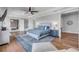 This is a large main bedroom with blue accents and an ensuite bathroom with stand alone tub at 1212 Commodore Dr, New Smyrna Beach, FL 32168