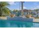 Beautiful pool area with mosaic tiled fountain and lush tropical landscaping, ideal for relaxation at 1212 Commodore Dr, New Smyrna Beach, FL 32168