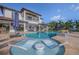 Relaxing pool with in-water loungers and umbrella in a spacious backyard with lush landscaping at 1212 Commodore Dr, New Smyrna Beach, FL 32168