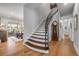 Elegant staircase featuring hardwood steps and iron railings, connecting different levels of the home with style at 1212 Commodore Dr, New Smyrna Beach, FL 32168