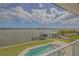 Backyard oasis with a pool, a private boat dock, and serene water views perfect for relaxation and entertainment at 1221 Commodore Dr, New Smyrna Beach, FL 32168