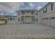 Elegant home with a stone driveway, a second-story balcony, and striking blue shutters that add a pop of color at 1221 Commodore Dr, New Smyrna Beach, FL 32168