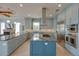 Spacious kitchen featuring a large island, stainless steel appliances, and custom cabinets for ample storage space at 1221 Commodore Dr, New Smyrna Beach, FL 32168